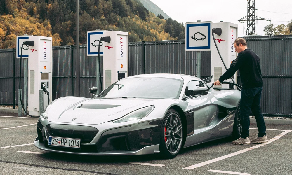 Electric performance car connected to a charging station.