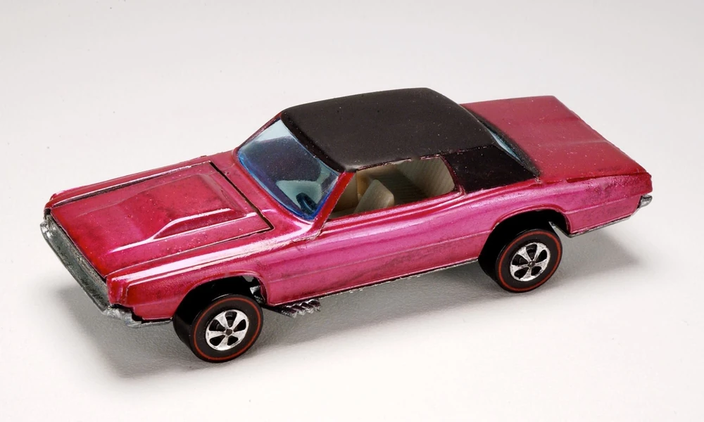 Vintage pink Redline-era Hot Wheels Custom Thunderbird with black roof and red-stripe tires